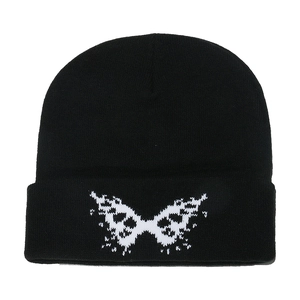 Black knitted beanie hat with white butterfly jacquard pattern in Y2K streetwear style