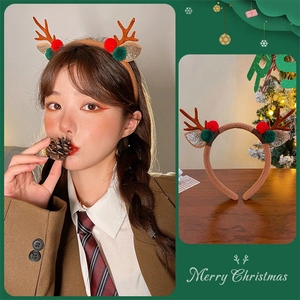 Brown plush Christmas reindeer antler headband with decorative pom poms and sequins