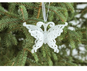 Sparkly white butterfly Christmas tree hanging ornament on green pine branch