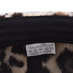Detail shot of leopard print corduroy cap interior with 100% polyester wash label