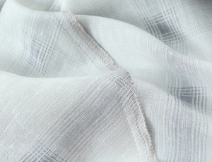 Macro shot of light gray plaid fabric showing detailed weave and precision stitching