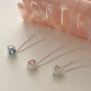 Detailed view of 925 sterling silver heart necklaces with blue, pink and clear zircons