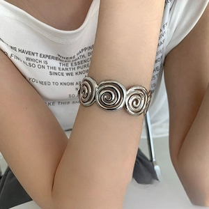 Polished silver spiral textured cuff bracelet for women with geometric metal swirl design