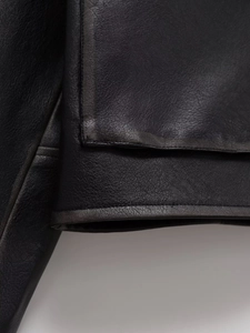 Detailed close-up of premium black PU leather texture with high-quality stitching on the jacket
