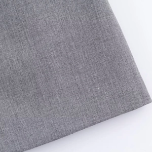 Detailed macro shot of high-quality grey woven fabric texture for women's bow dress