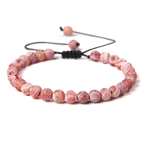 Detail of pink cracked agate beads on a hand-woven adjustable black cord bracelet