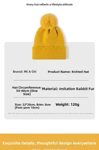 Détail du bonnet en maille jaune vif avec grand pompon décoratif en imitation fourrure