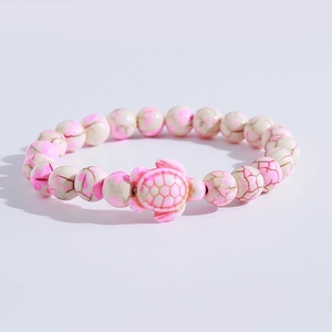 Detailed view of pink and white crackle texture beads with sea turtle charm