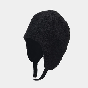Close-up of black corduroy trapper hat featuring thick thermal faux shearling lining
