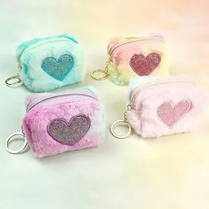 Detailed view of plush heart mini wallets with rainbow embroidery and gold keyrings