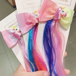 Detail of unicorn hair clips with colorful synthetic extensions for kids accessories