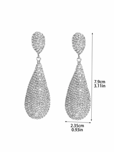 Macro shot of silver drop earrings with crystal pavé and size dimensions in inches