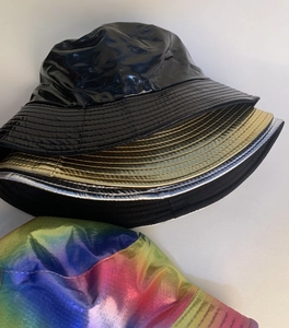Detailed stack of glossy faux leather and metallic finish bucket hats in multiple colors