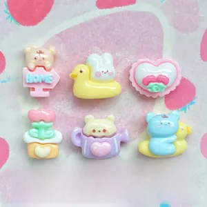 Macro view of assorted resin charms including mini bears and rabbits for DIY crafts