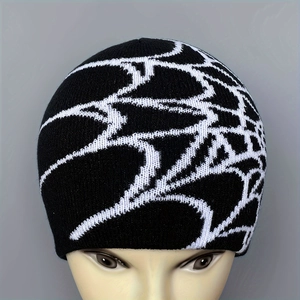 Classic black and white knit beanie featuring an abstract spider web pattern for winter warmth