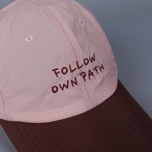 Lightweight breathable baseball cap in pink and brown with embroidered text detailing