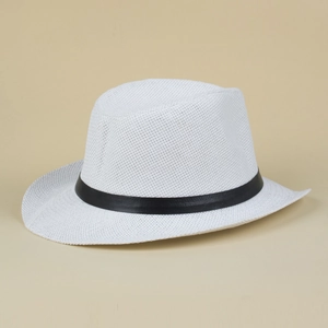 Detail of white straw jazz hat with black ribbon, breathable texture for summer beach