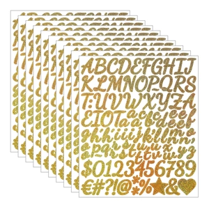 Macro detail of 1-inch gold glitter alphabet stickers for graduation cap decoration