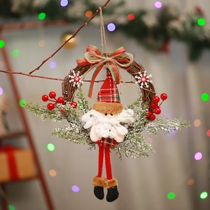 Detail of Christmas wreath with plush Santa Claus, green pine needles and red berries