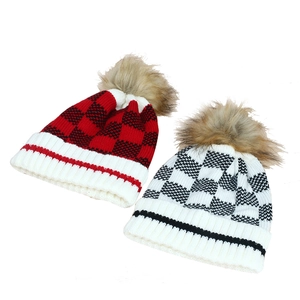 Women's knit pompom beanie set with red and white plaid patterns and faux fur details