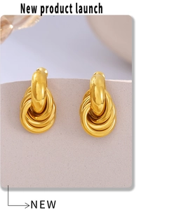 Detailed macro of interlinked golden multi-loop stud earrings with high-polish finish