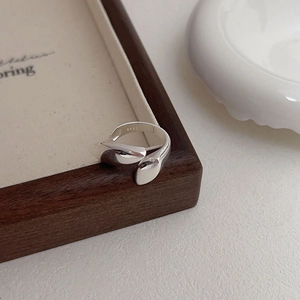 Detailed close-up of S925 sterling silver stamp on a minimalist organic fluid open ring