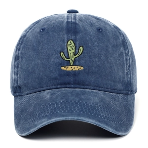 Detail of green cactus embroidery on vintage washed blue denim cotton baseball cap
