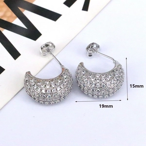 Macro shot of silver C-shaped rhinestone earrings with measurements 15mm and 19mm