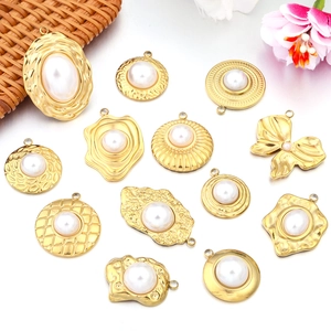 Detailed view of assorted gold sunflower and baroque pearl pendant charms for DIY jewelry