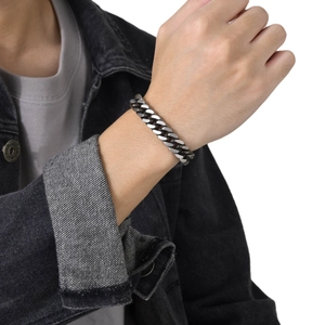 Men's retro Cuban link bracelet in dark gray stainless steel worn on wrist