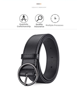 Detail of minimalist black PU leather belt with sleek dark grey circular metal buckle