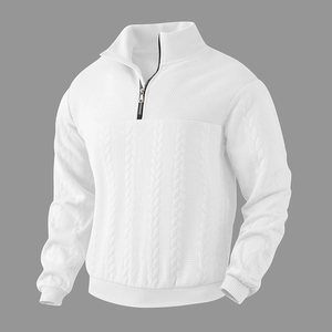 Detail of white men's quarter-zip sweater showing knit cable patterns and metal zipper
