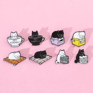 Macro view of 8 cute cat enamel pins featuring cats with coffee cups and books