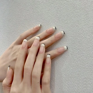 French tip press-on nails with black and white line design on long square nude base