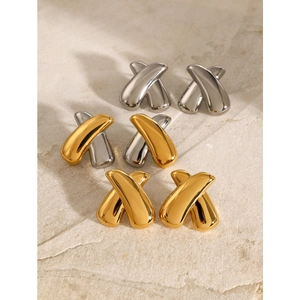 Polished 18k gold and silver stainless steel chunky X-shaped earrings on stone surface
