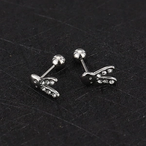 Macro shot of silver bunny stud earrings with sparkling zircons and threaded ball backings