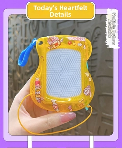 Close-up of a yellow guitar-shaped mini magnetic drawing board keychain with charms