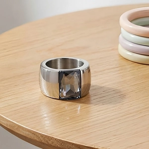 Macro detail of wide silver titanium steel ring with a large rectangular grey gemstone