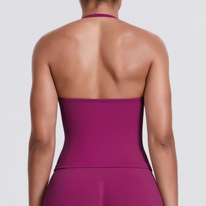 Detail of a seamless backless fitness top in plum with moisture-wicking stretch fabric
