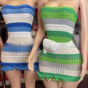 Detail of hand-crocheted strapless knit mini dress with wavy hem and striped pattern