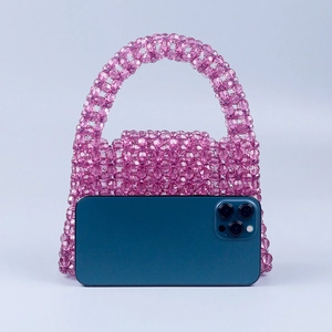 Detailed close-up of handmade pink beaded handbag with trapezoid shape and size reference