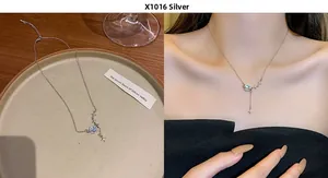 Detail of silver titanium necklace with blue planet and zircon bow tie star pendant
