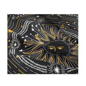 Close-up of fabric texture showing sun and star patterns on mystical tarot tapestry
