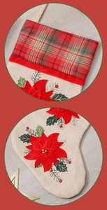 Detail view of Christmas stocking featuring red poinsettia applique and plaid cuff fabric