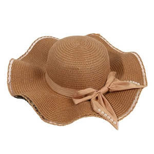 Women's wide brim straw hat with white lace trim and pearl bow detail for beach sun protection