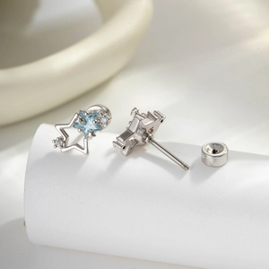Minimalist star-shaped titanium steel studs with blue and clear zircon and screw-back closure