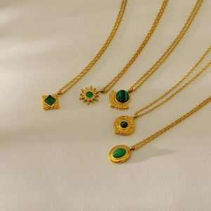 Vintage gold necklaces with emerald green pendants in various shapes on white background