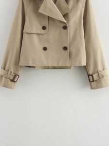 Flat lay of a khaki short trench coat featuring a double-breasted design and large lapels