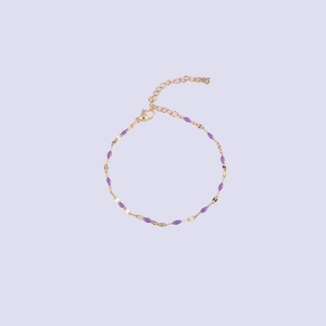 Detail of gold chain bracelet featuring purple enamel charms and adjustable lobster clasp