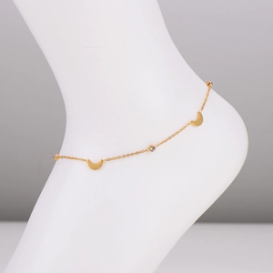 Elegant gold stainless steel moon anklet with zircon charms on a foot model